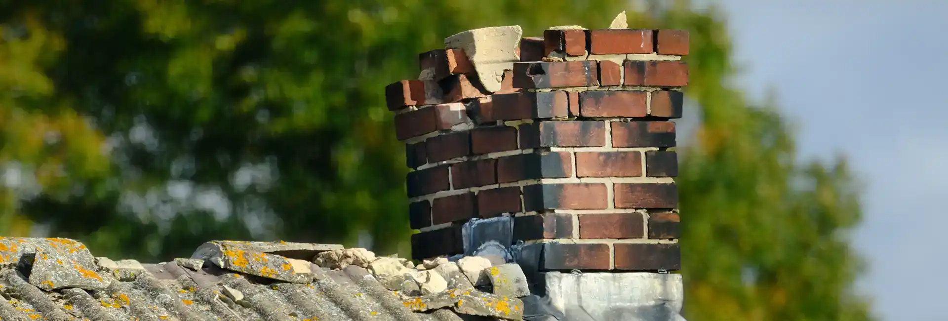 Fluecheck offer brick chimney repair services. The image shows a brick chimney in desperate need of repair
